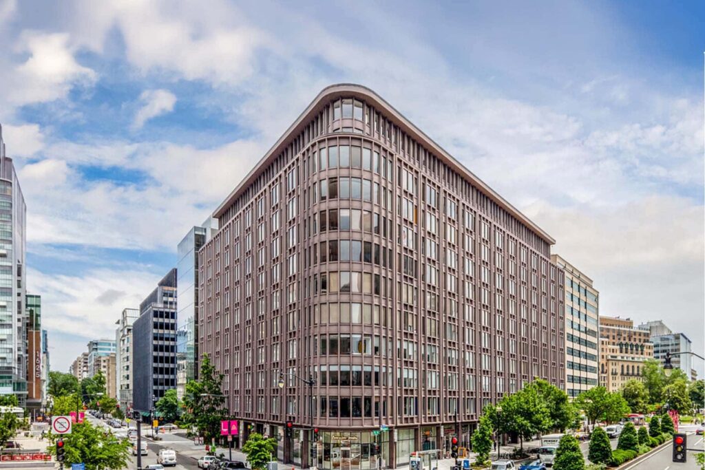 A high-rise commercial office building in a busy city center.
